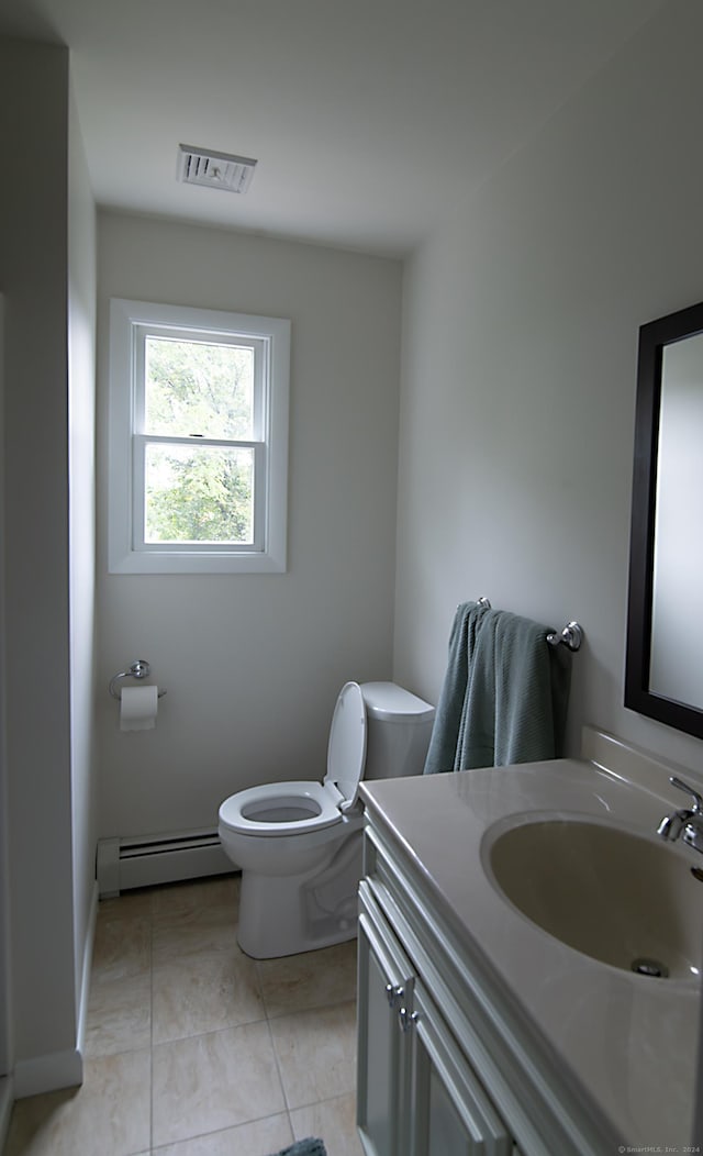 bathroom with vanity, a baseboard heating unit, tile patterned flooring, and toilet