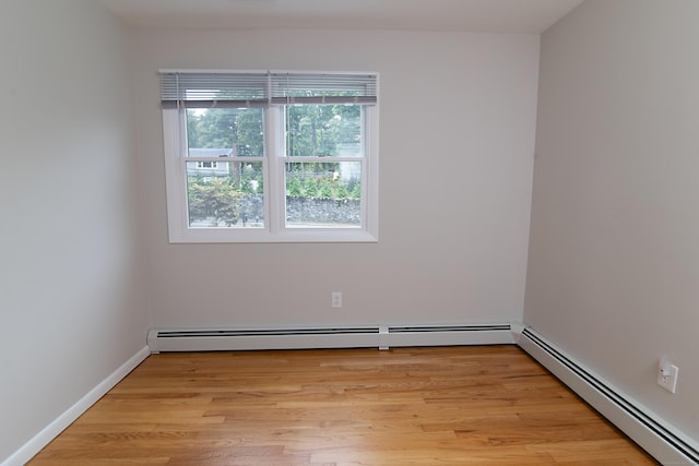 spare room with light hardwood / wood-style flooring and a baseboard radiator