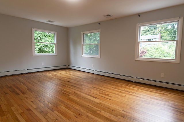 unfurnished room with a healthy amount of sunlight and light wood-type flooring