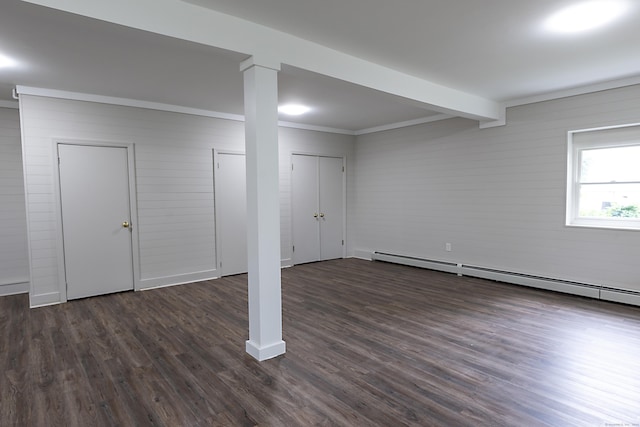 basement featuring a baseboard radiator, ornamental molding, and dark hardwood / wood-style floors