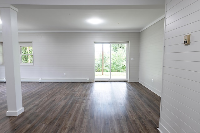 spare room featuring wooden walls, a baseboard radiator, ornamental molding, and dark hardwood / wood-style floors