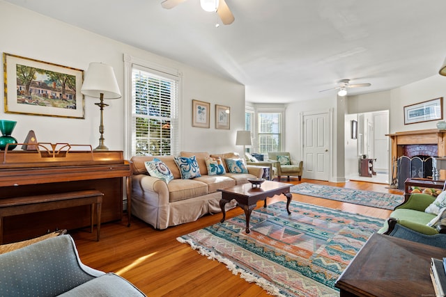 living room featuring ceiling fan and hardwood / wood-style floors