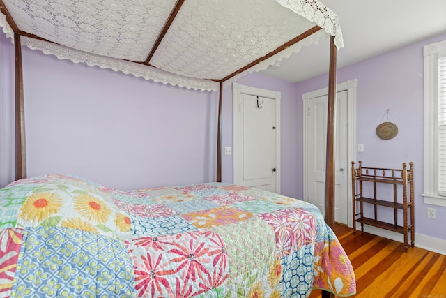 bedroom featuring hardwood / wood-style flooring and a closet