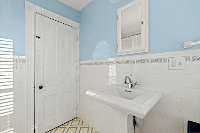 bathroom with tile walls