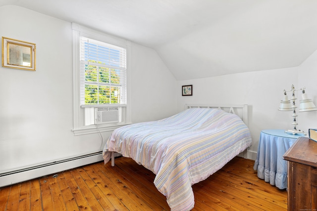 bedroom featuring lofted ceiling, baseboard heating, and hardwood / wood-style floors