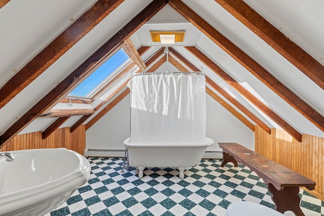 bathroom featuring vaulted ceiling with skylight, a bathtub, a baseboard heating unit, and wooden walls