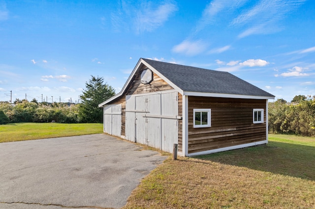 view of outbuilding with a yard