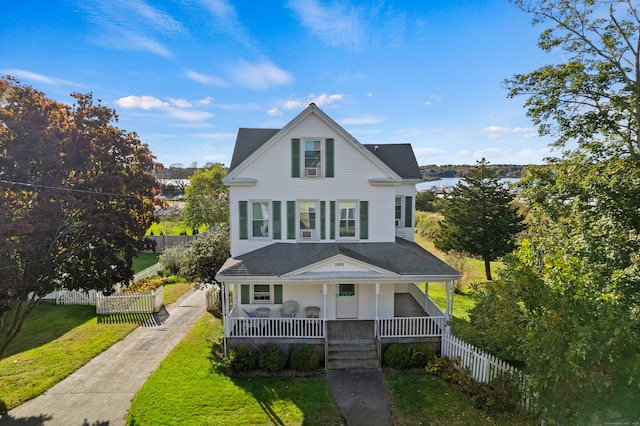 view of front facade featuring covered porch and a front yard