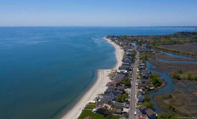 drone / aerial view with a water view and a beach view