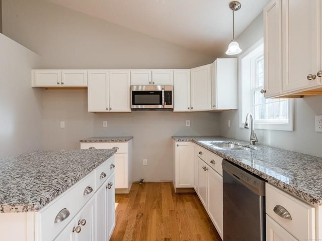 kitchen with light hardwood / wood-style floors, sink, lofted ceiling, appliances with stainless steel finishes, and white cabinetry