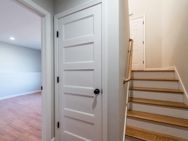 staircase with hardwood / wood-style flooring