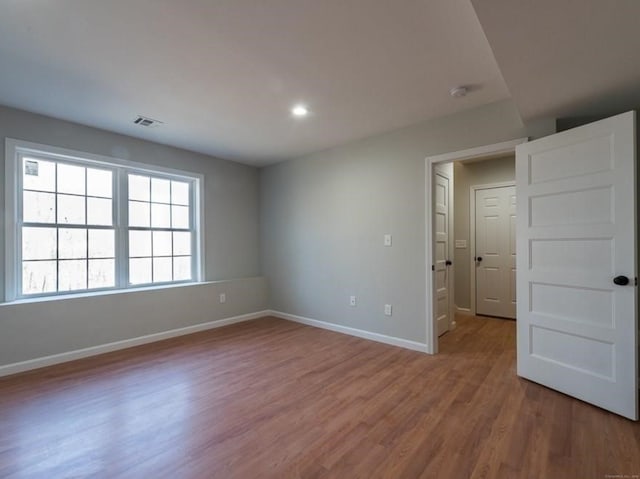 empty room with hardwood / wood-style floors