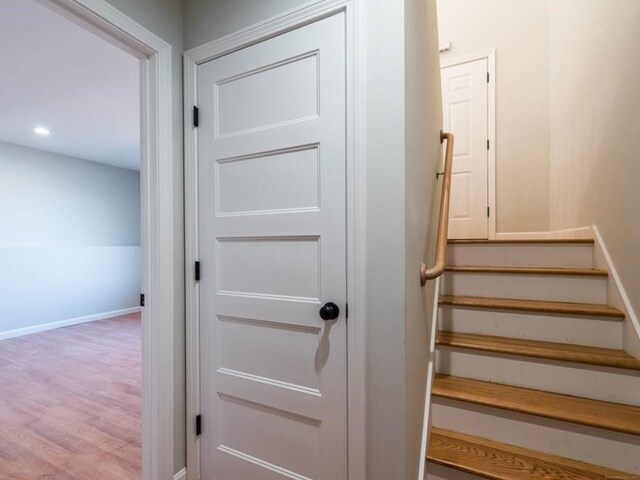 stairs featuring hardwood / wood-style floors