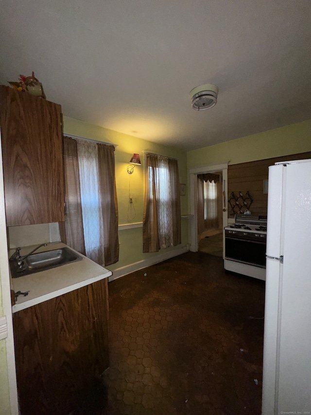 kitchen featuring white appliances and sink