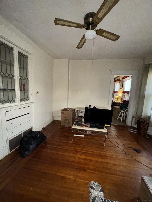 living room featuring hardwood / wood-style flooring and ceiling fan