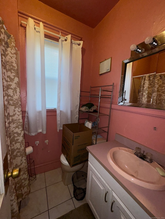 bathroom with toilet, tile patterned flooring, and vanity