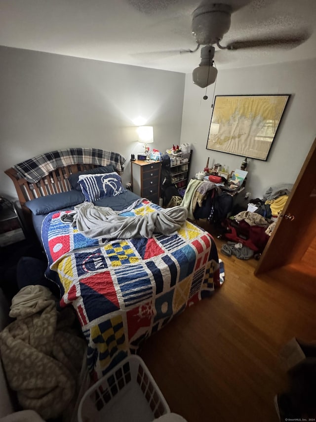 bedroom featuring ceiling fan and wood finished floors