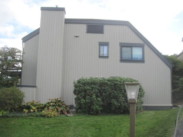 view of home's exterior with a yard