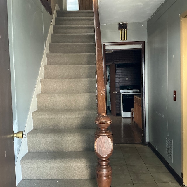 stairway with tile patterned floors