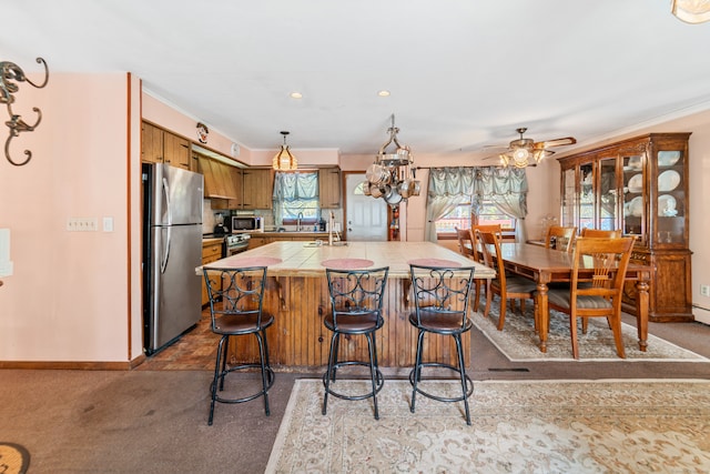 kitchen featuring light carpet, appliances with stainless steel finishes, plenty of natural light, and tile countertops