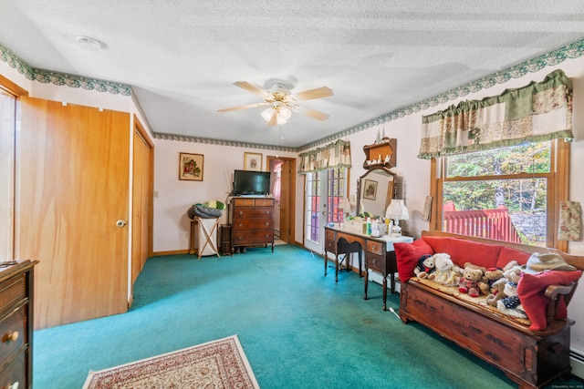 home office featuring ceiling fan, a baseboard heating unit, carpet floors, and a textured ceiling