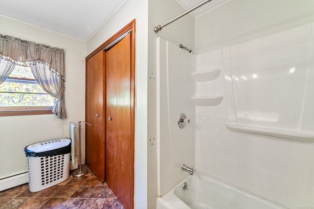 bathroom featuring tub / shower combination and a baseboard heating unit