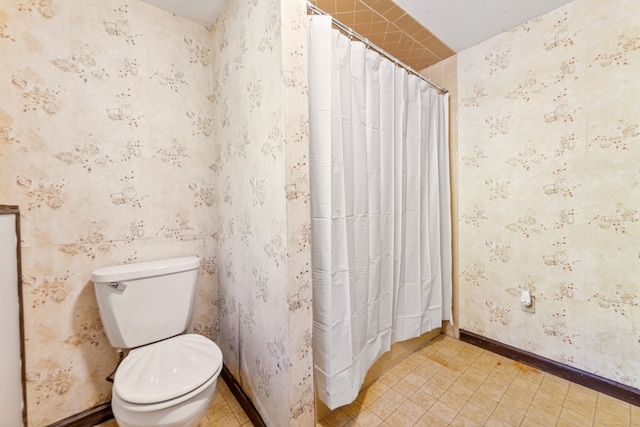 bathroom with tile patterned flooring, toilet, and a shower with shower curtain