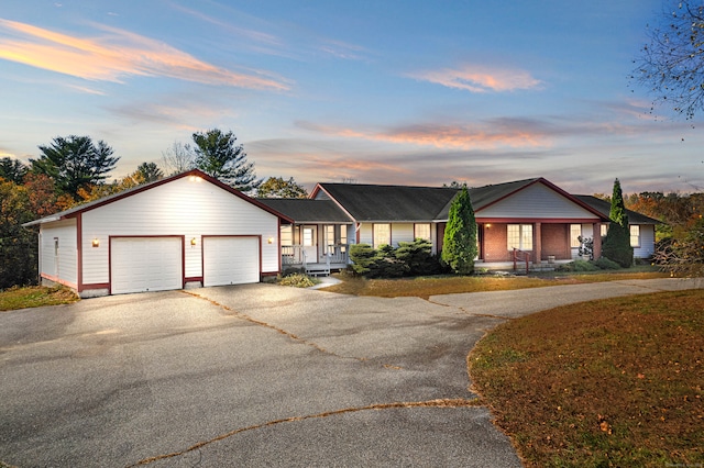 ranch-style house featuring a garage and a porch