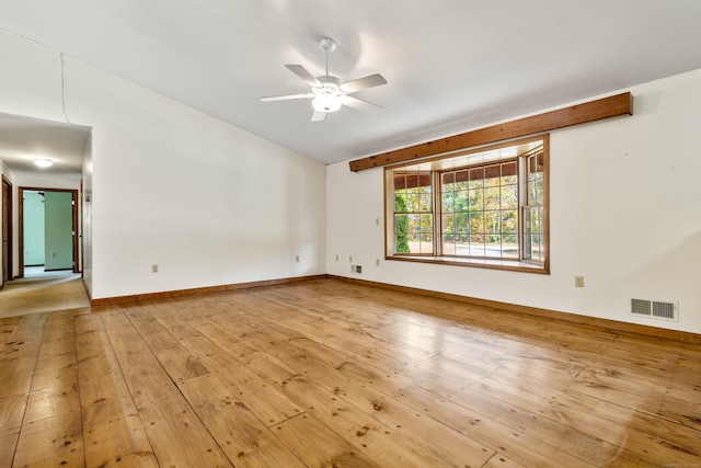 unfurnished room with ceiling fan, baseboards, light wood finished floors, and visible vents