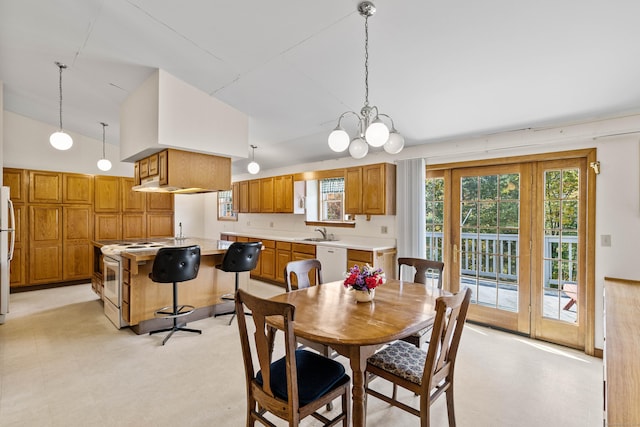 dining area with high vaulted ceiling, a notable chandelier, and light floors