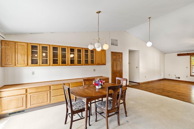 dining space with vaulted ceiling, visible vents, and a notable chandelier