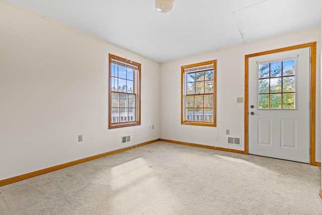 interior space with baseboards, a healthy amount of sunlight, and visible vents
