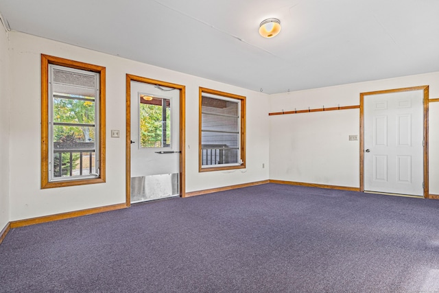 carpeted empty room with baseboards