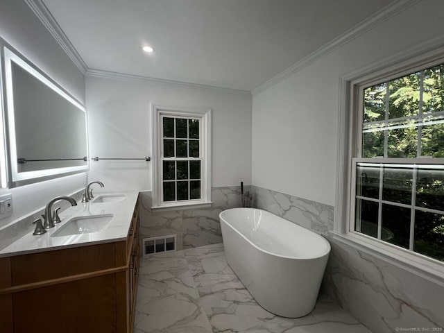 144 Hawks Hill Rd, New Canaan, CT 06840 - bathroom featuring a freestanding tub, double vanity, tile walls, marble finish floors, and wainscoting