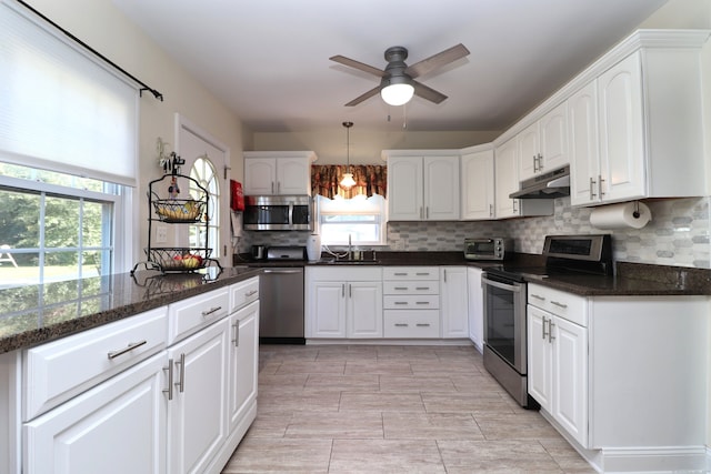 kitchen featuring appliances with stainless steel finishes, ceiling fan, and white cabinetry