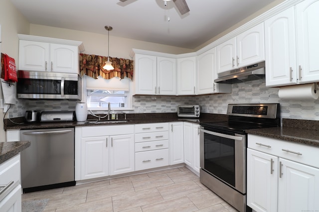 kitchen with ceiling fan, white cabinets, appliances with stainless steel finishes, and sink