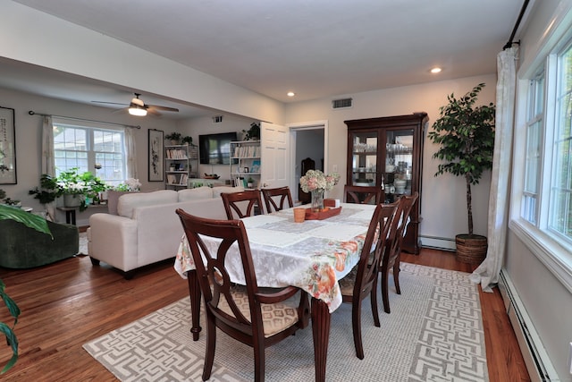 dining room with hardwood / wood-style flooring, ceiling fan, and baseboard heating