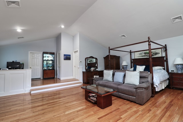 bedroom featuring lofted ceiling and light wood-type flooring