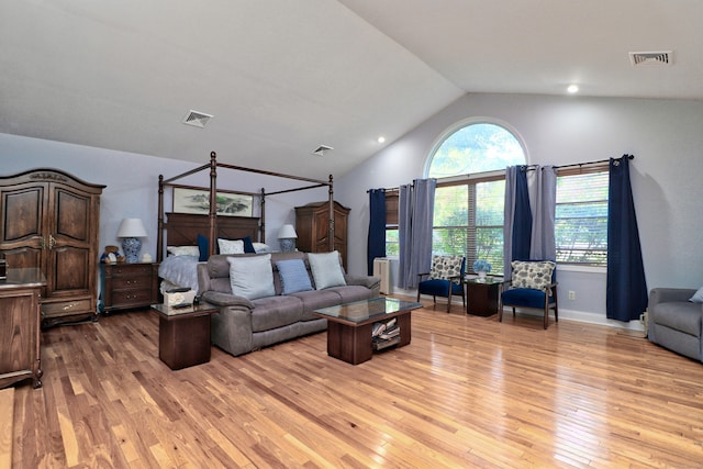 living room featuring light hardwood / wood-style floors and vaulted ceiling