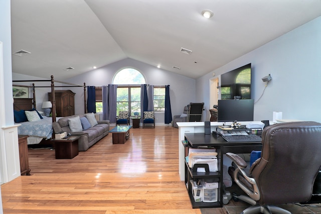 office featuring lofted ceiling and light hardwood / wood-style flooring