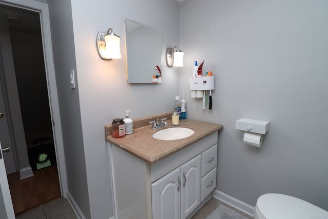 bathroom with vanity, tile patterned flooring, and toilet