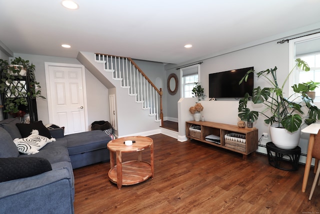 living room with baseboard heating and dark hardwood / wood-style floors