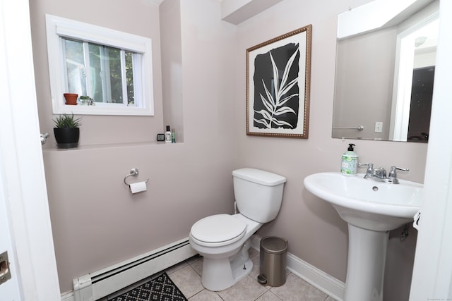 bathroom with sink, baseboard heating, toilet, and tile patterned floors