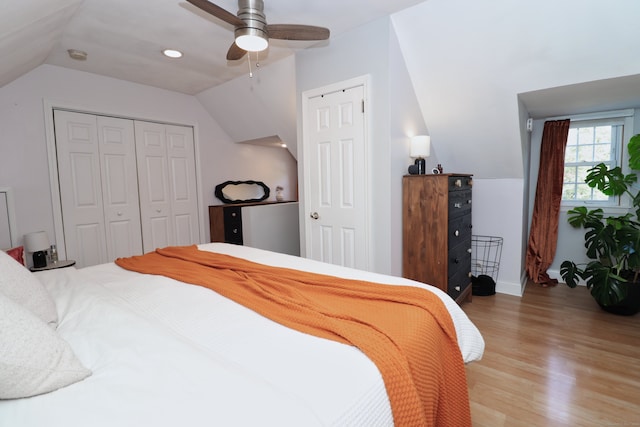 bedroom with lofted ceiling, ceiling fan, and light wood-type flooring