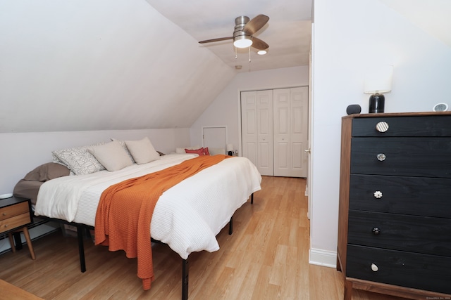 bedroom with a closet, vaulted ceiling, light wood-type flooring, and ceiling fan