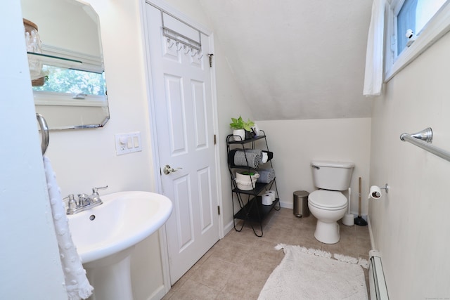 bathroom featuring tile patterned floors, toilet, a baseboard radiator, and vaulted ceiling