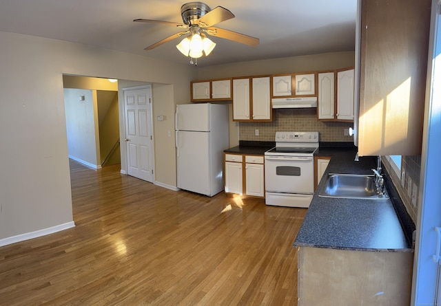 kitchen with sink, light hardwood / wood-style floors, tasteful backsplash, and white appliances