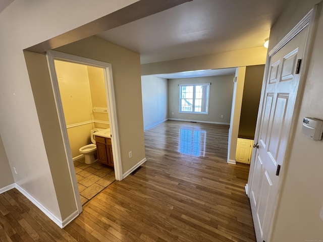 hallway with wood-type flooring