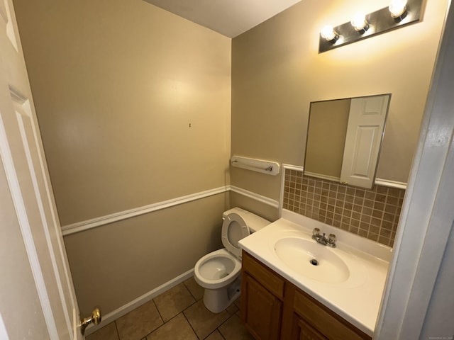 bathroom with toilet, tile patterned floors, tasteful backsplash, and vanity