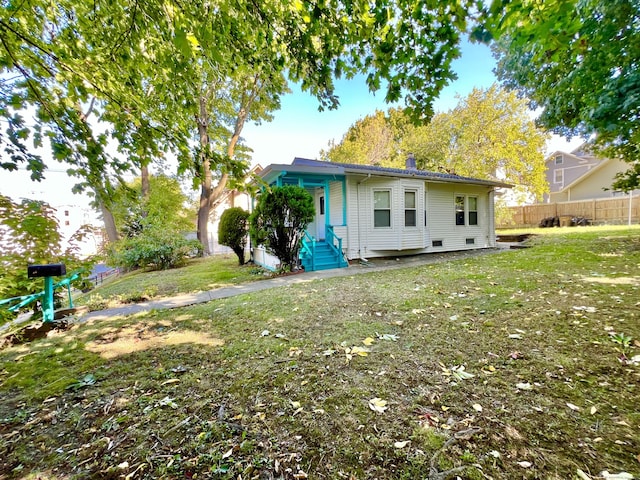 rear view of house with a yard